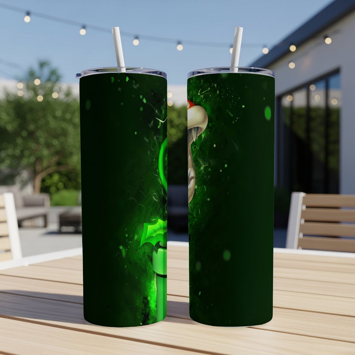 Green Grinch character on a dark green tumbler with straw, outdoors.