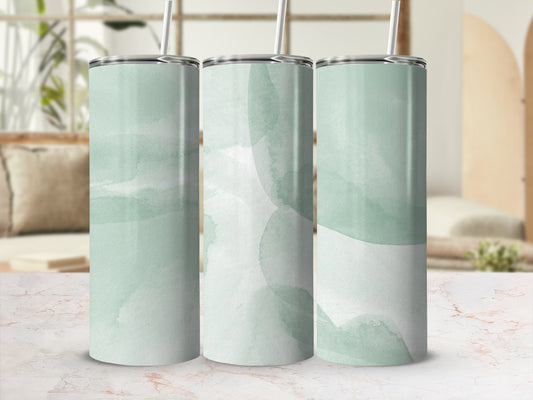Three mint green watercolor tumblers with straws on a marbled surface.