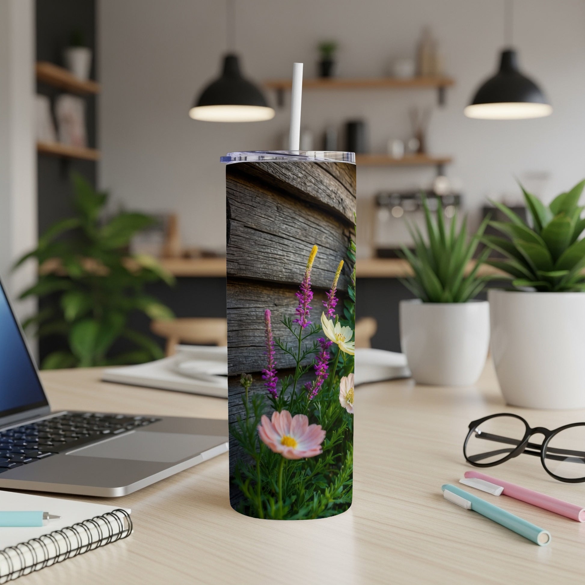 Tall tumbler with a rustic wooden background and colorful wildflowers.