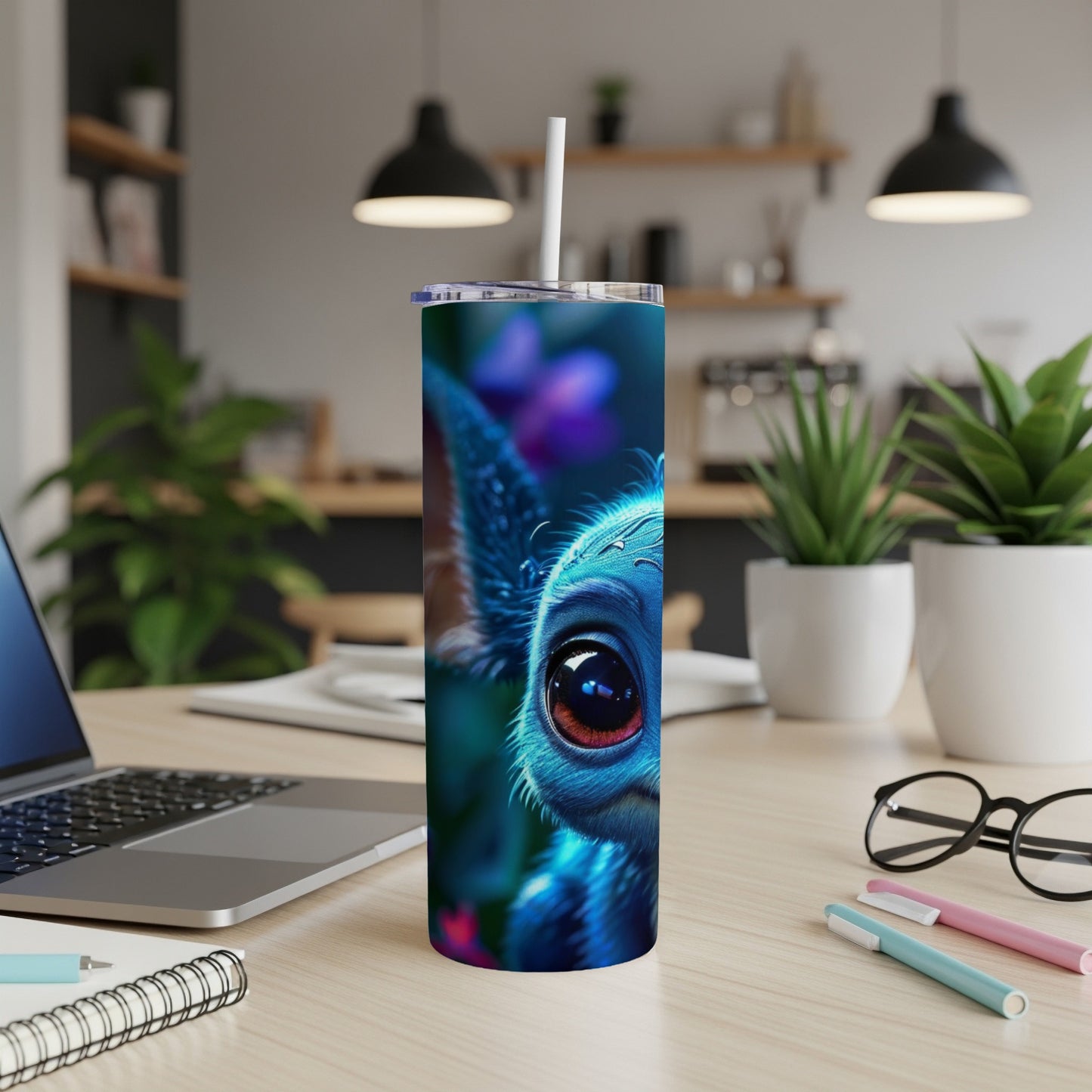 Blue creature with large eye on a textured tumbler with a straw.