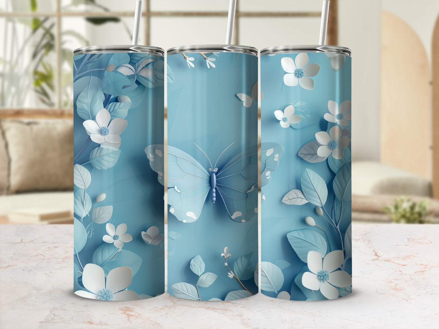 Blue tumbler with butterfly and floral design on a blurred background.
