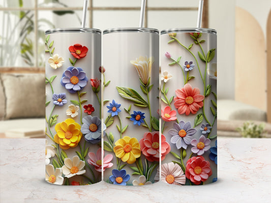 Three tumblers with raised colorful flowers and green leaves.