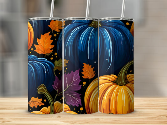 Three tumblers with pumpkin and fall leaf designs on a wooden surface.