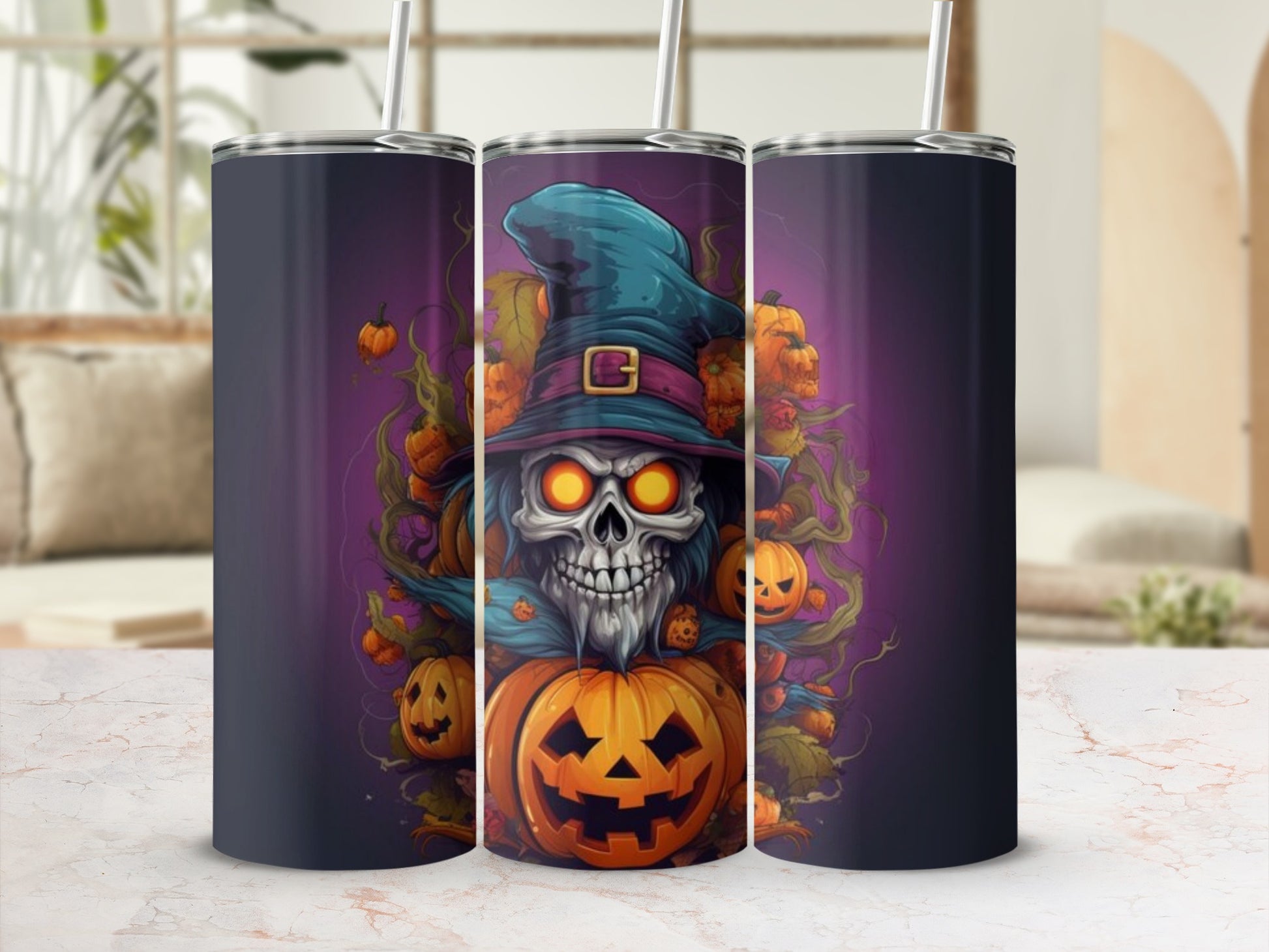 Halloween skull and pumpkin graphic on three tumblers with straws.