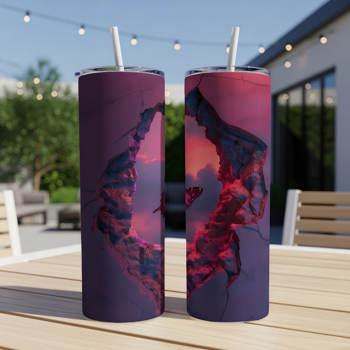Two tumblers with a dark, cracked opening revealing a purple and pink sunset sky with a butterfly.