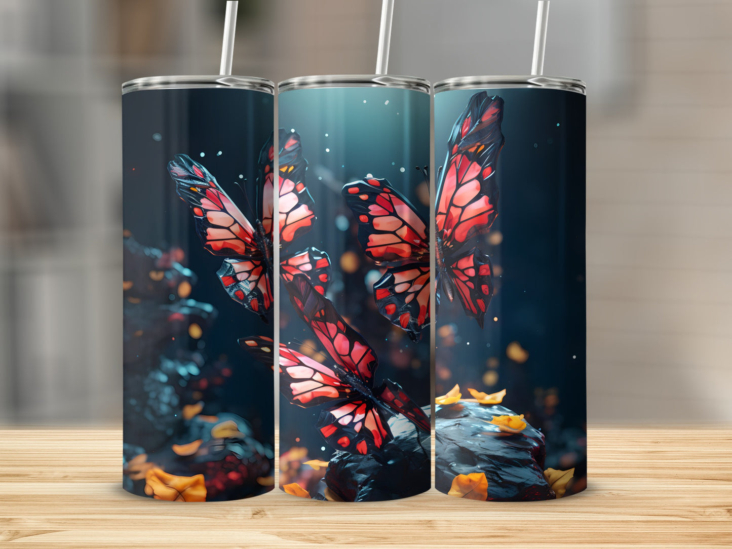 Three tall tumblers with colorful butterflies and scattered leaves on a wooden surface.