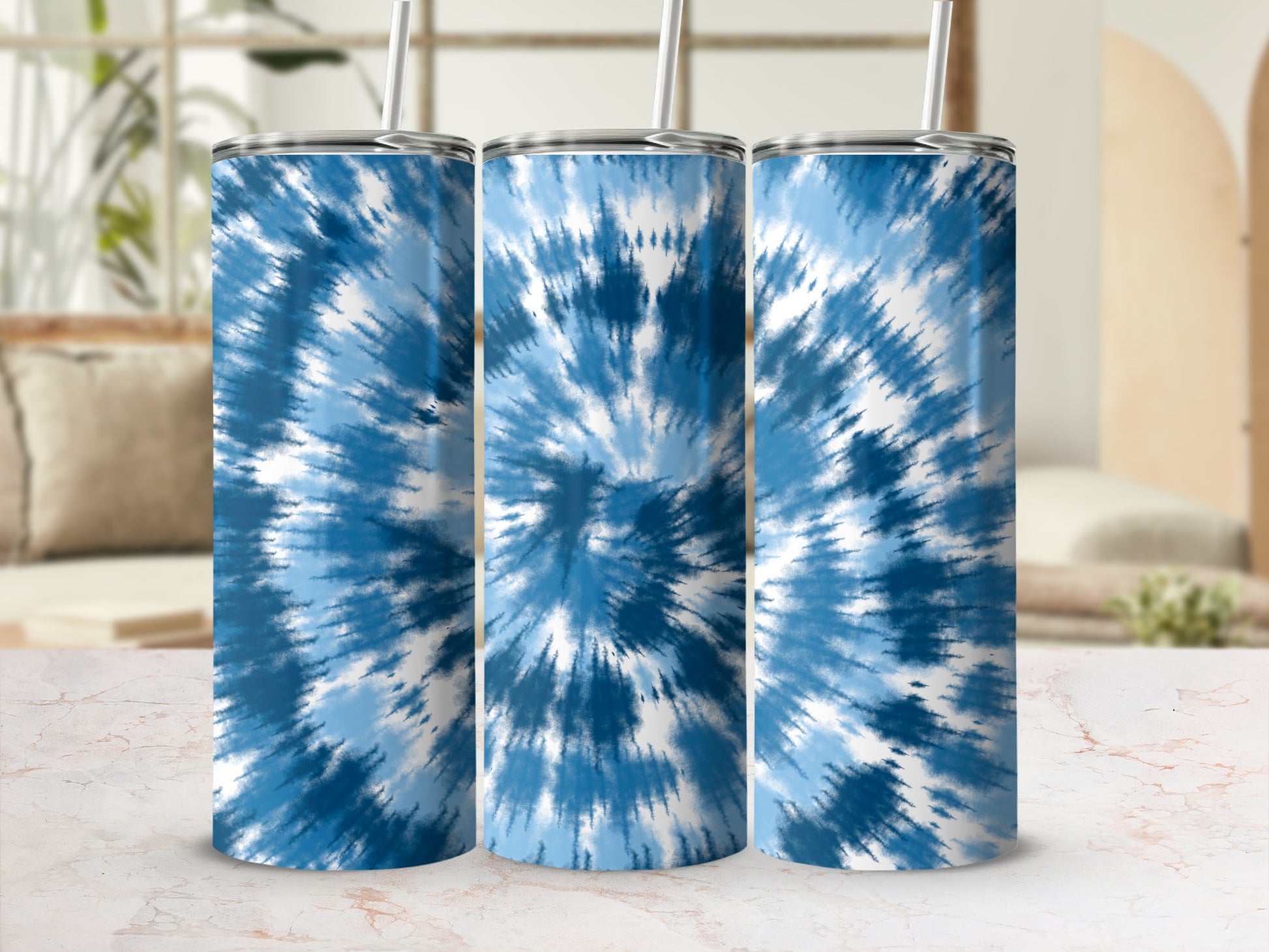 Three tumblers with blue and white tie-dye pattern and straws.