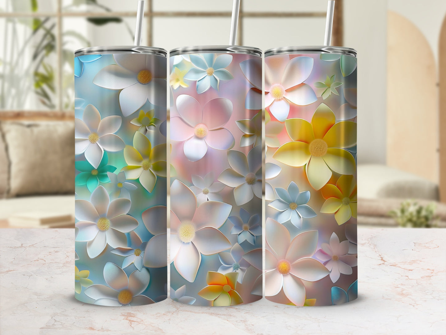 Three tumblers with colorful floral designs, displayed side-by-side.