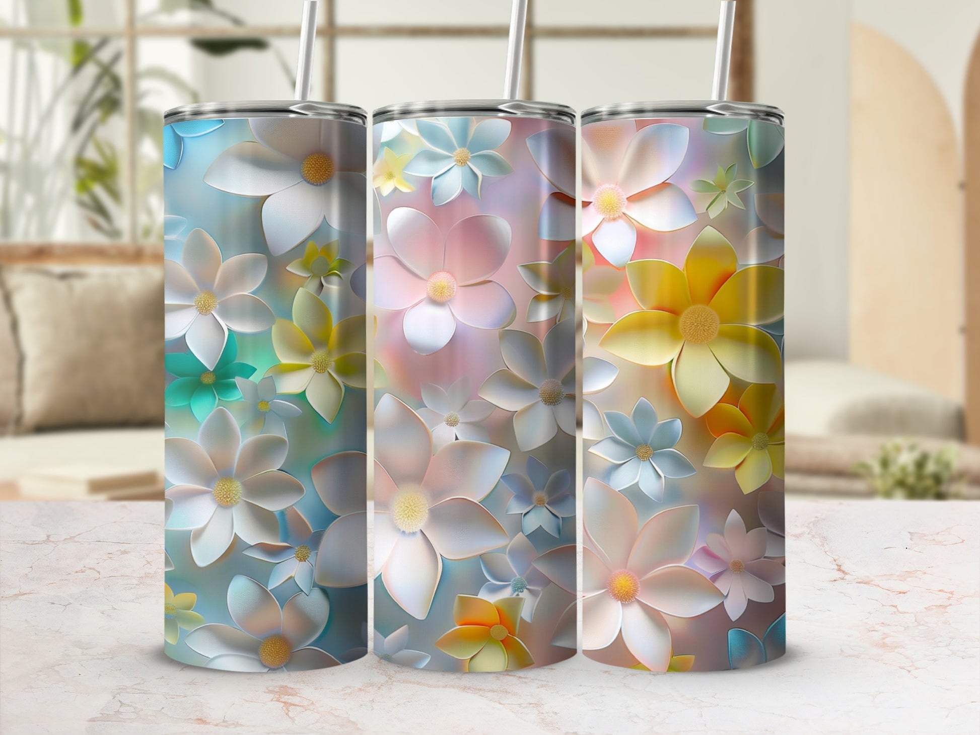 Three tumblers with colorful floral designs, displayed side-by-side.