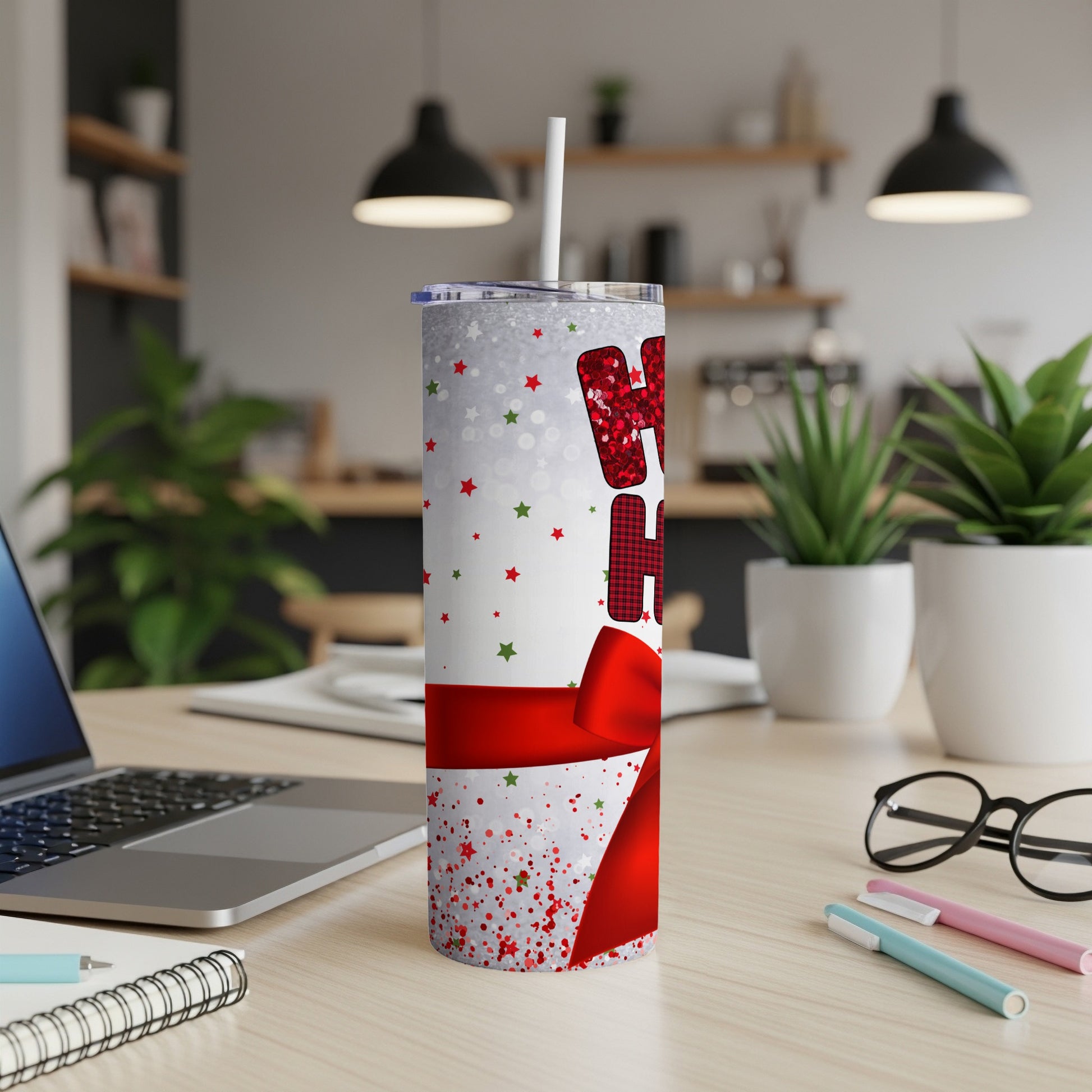 Glittery "Ho Ho Ho" tumbler with red ribbon and Christmas-themed background.