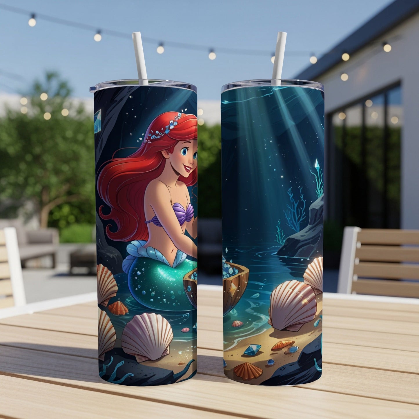 Disney's Ariel the mermaid on a tumbler with seashells and seabed.