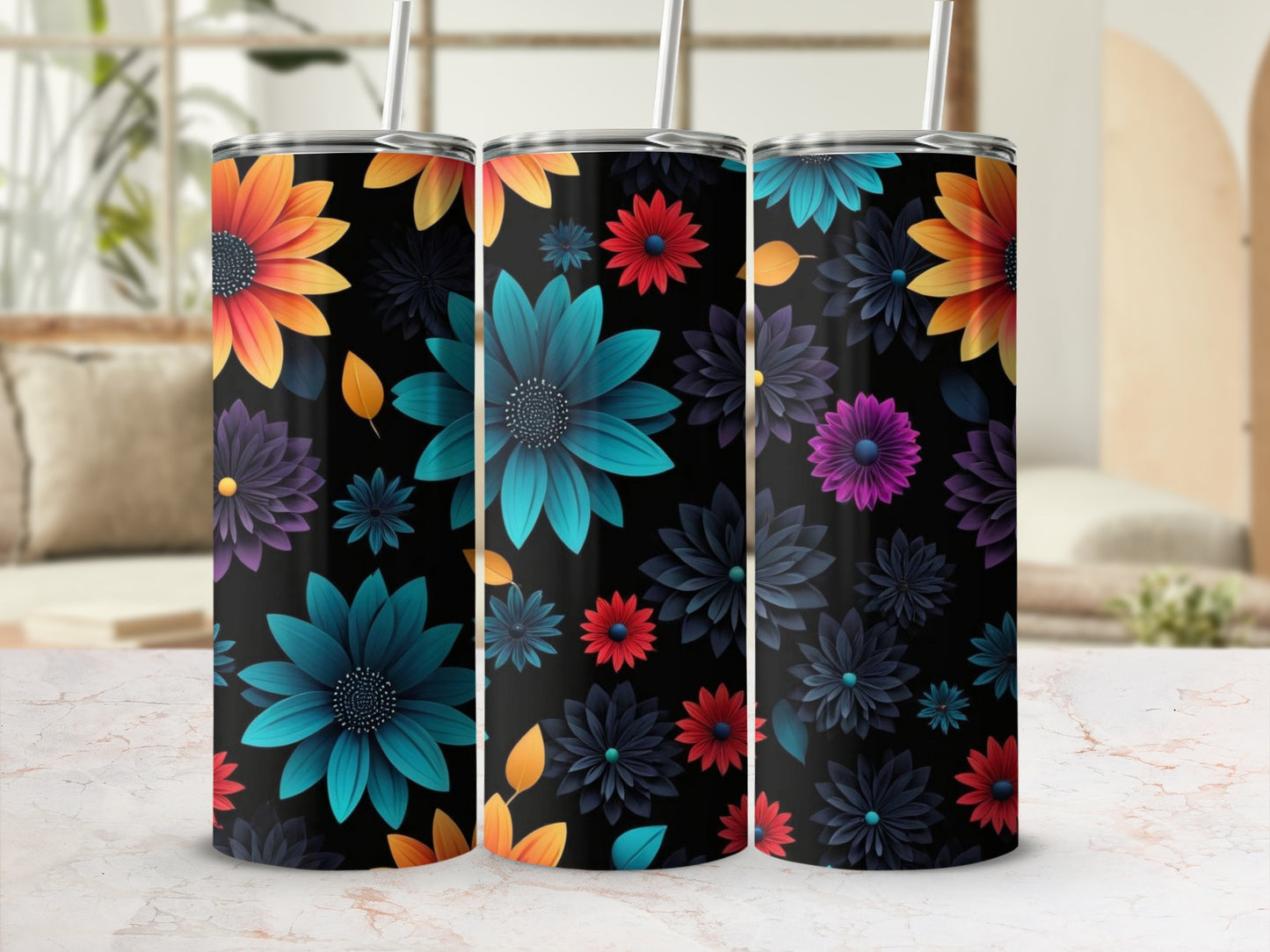 Three tumblers with colorful floral patterns on a marble countertop.