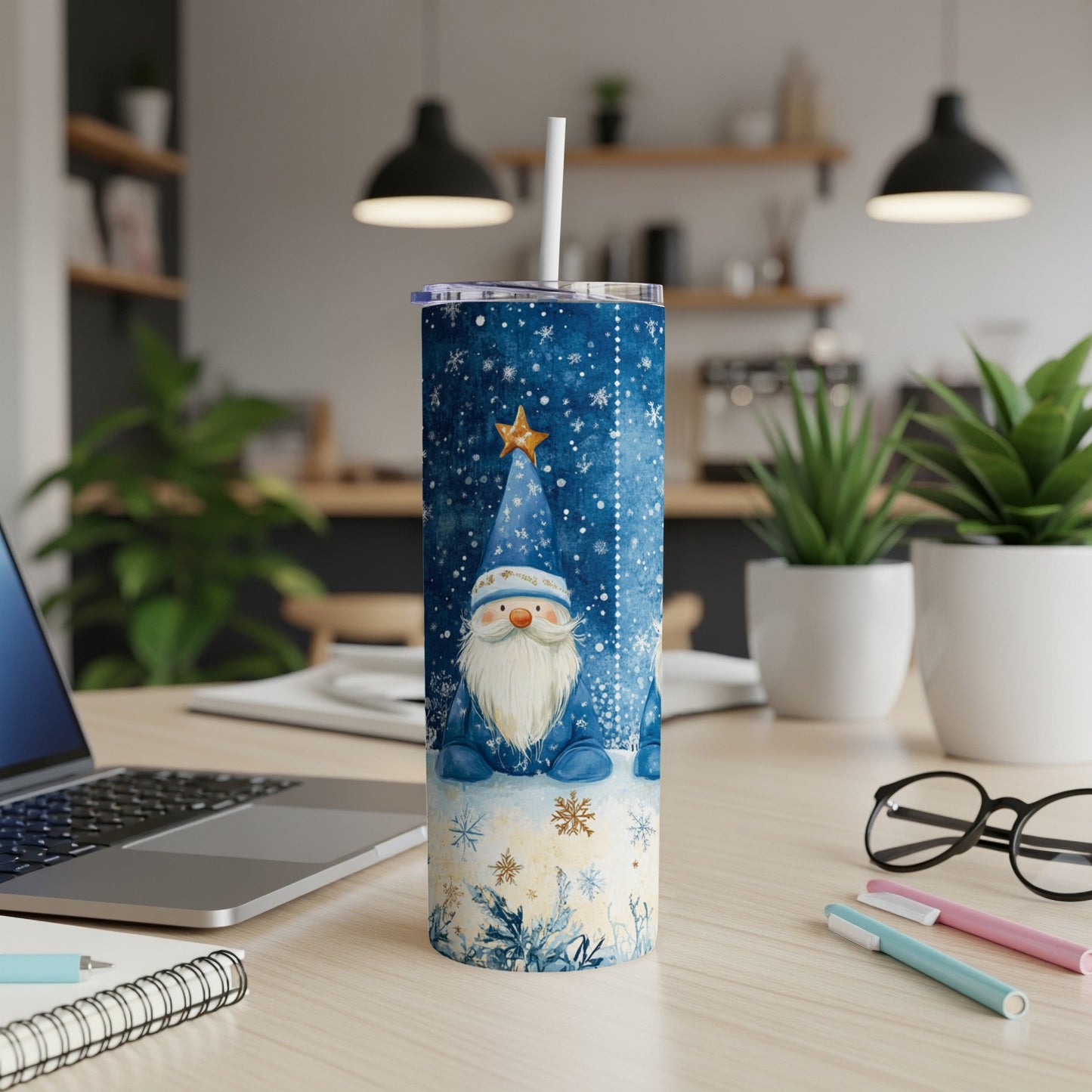 Blue tumbler with gnome and snowflakes, straw inserted.