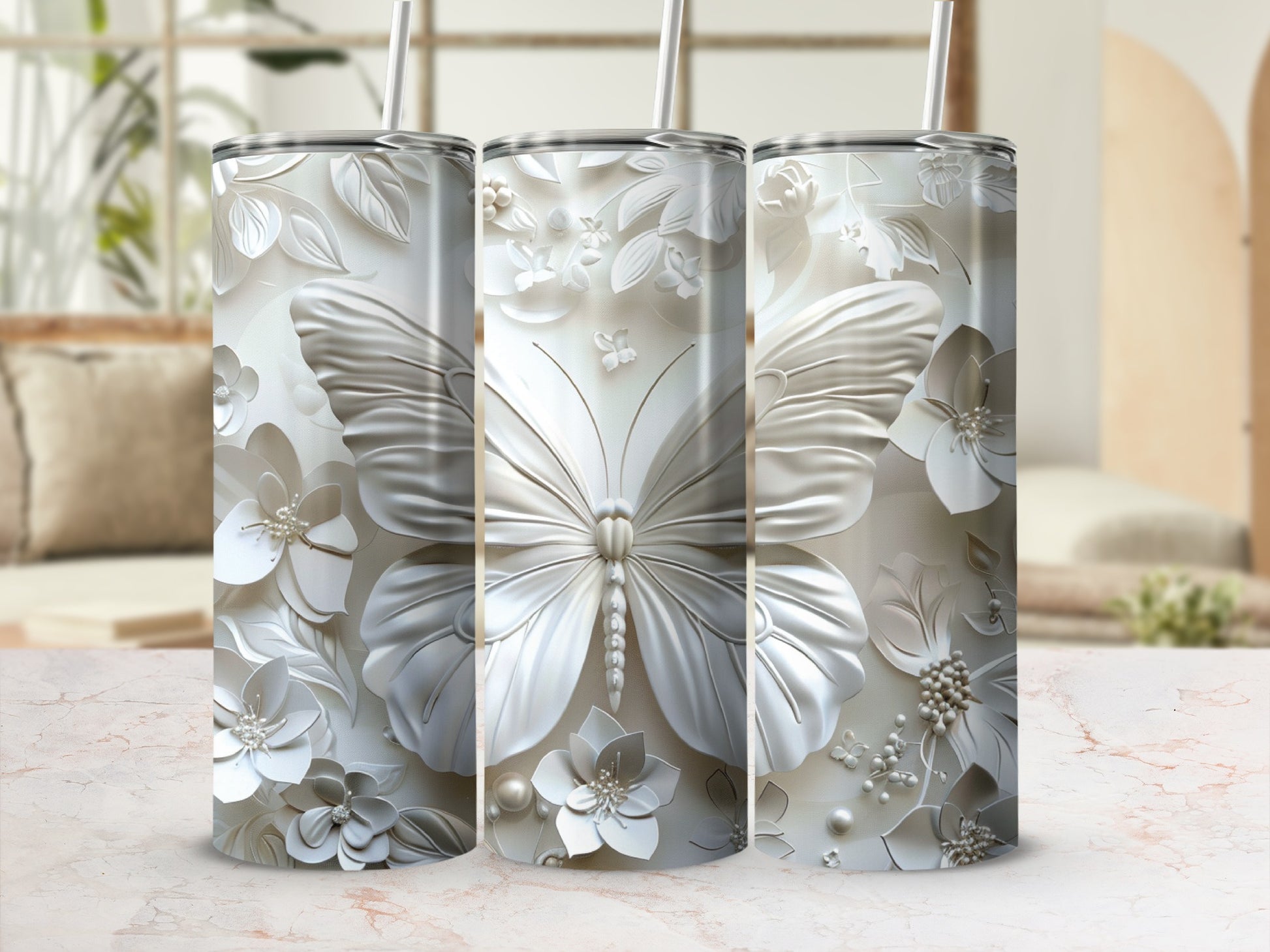 Three white tumblers with embossed butterfly and floral designs.