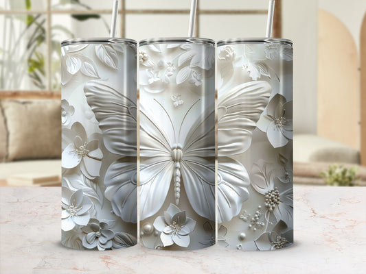 Three white tumblers with embossed butterfly and floral designs.