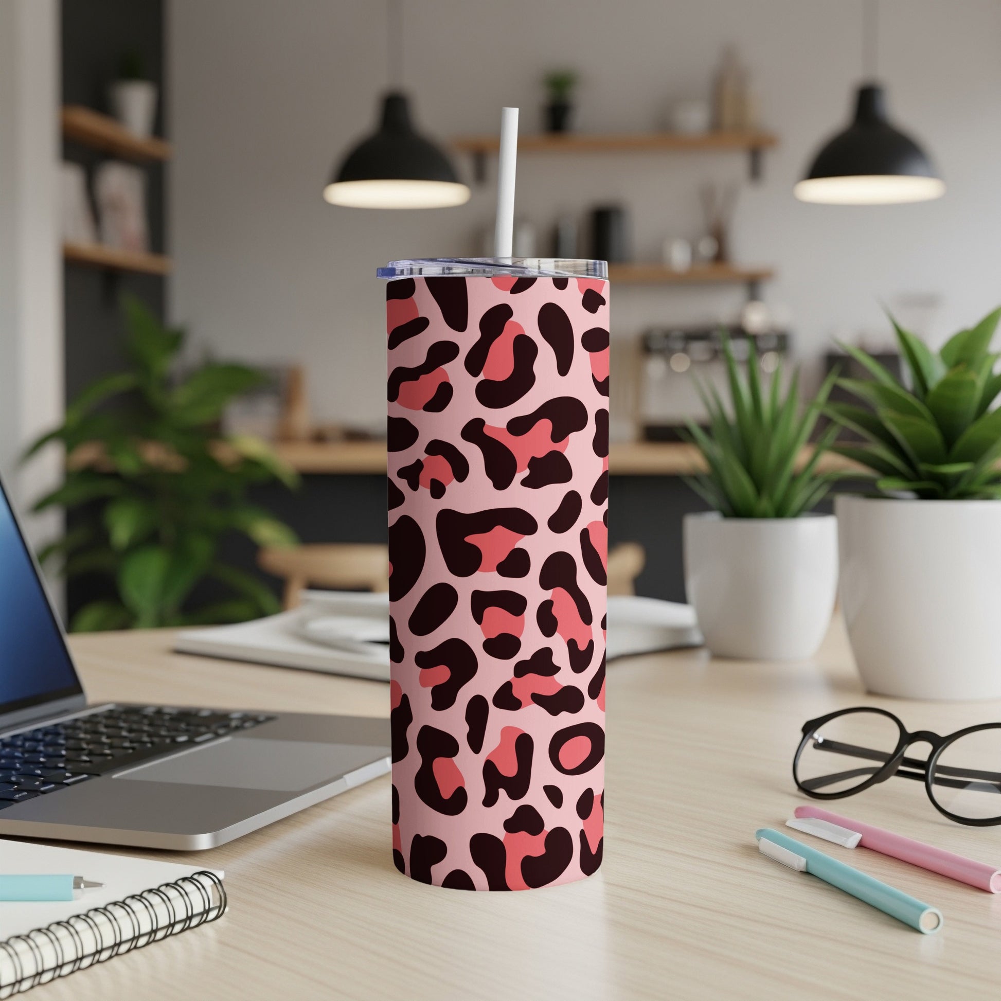 Pink tumbler with a dark pink and lighter pink leopard print pattern and straw.