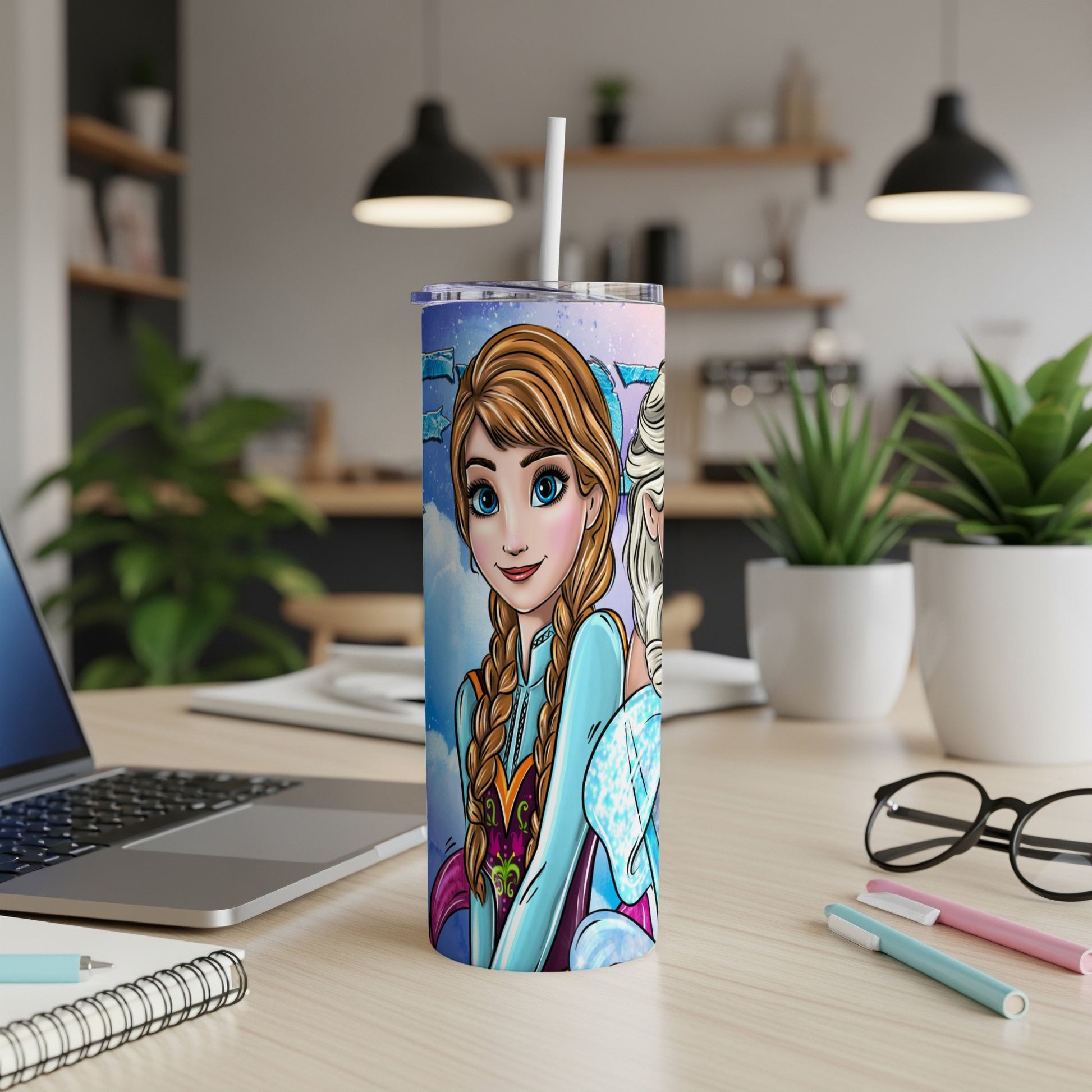 Frozen characters Elsa and Anna on a blue tumbler with straw, on a desk.