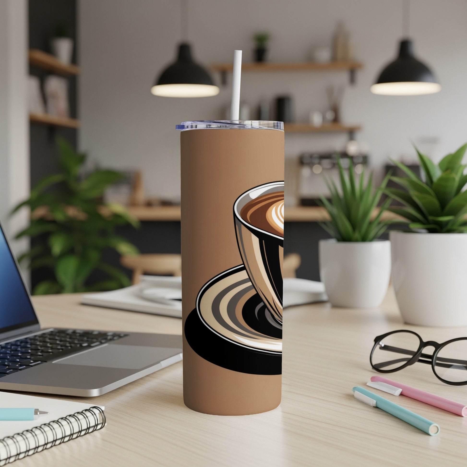 Brown tumbler with coffee cup illustration and straw, on a desk.