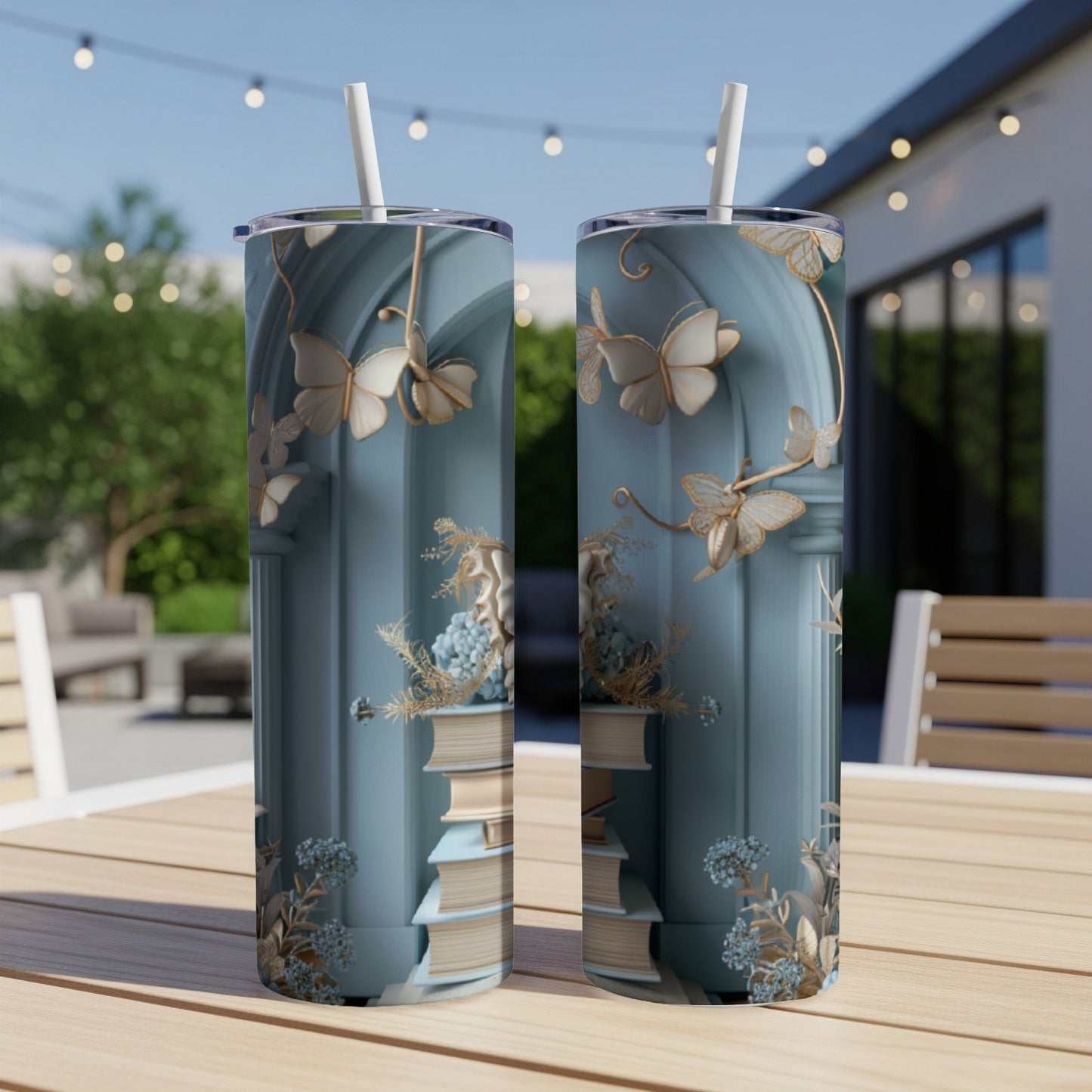 Two blue tumblers with gold butterflies and stacked books design.
