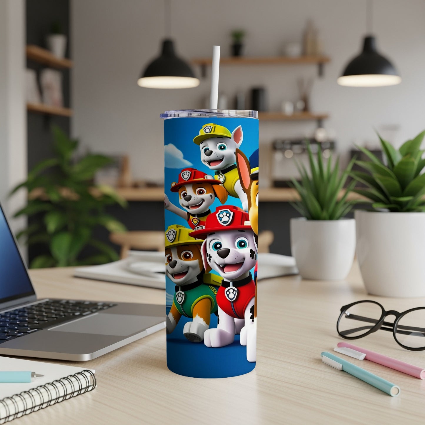 Paw Patrol characters on a blue tumbler with a straw.