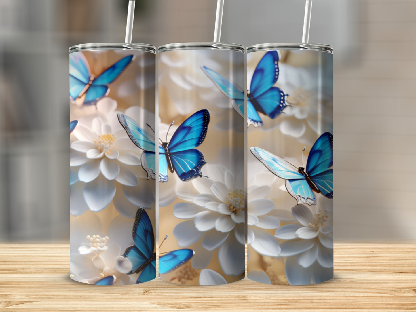 Three tumblers with blue butterflies and white flowers.