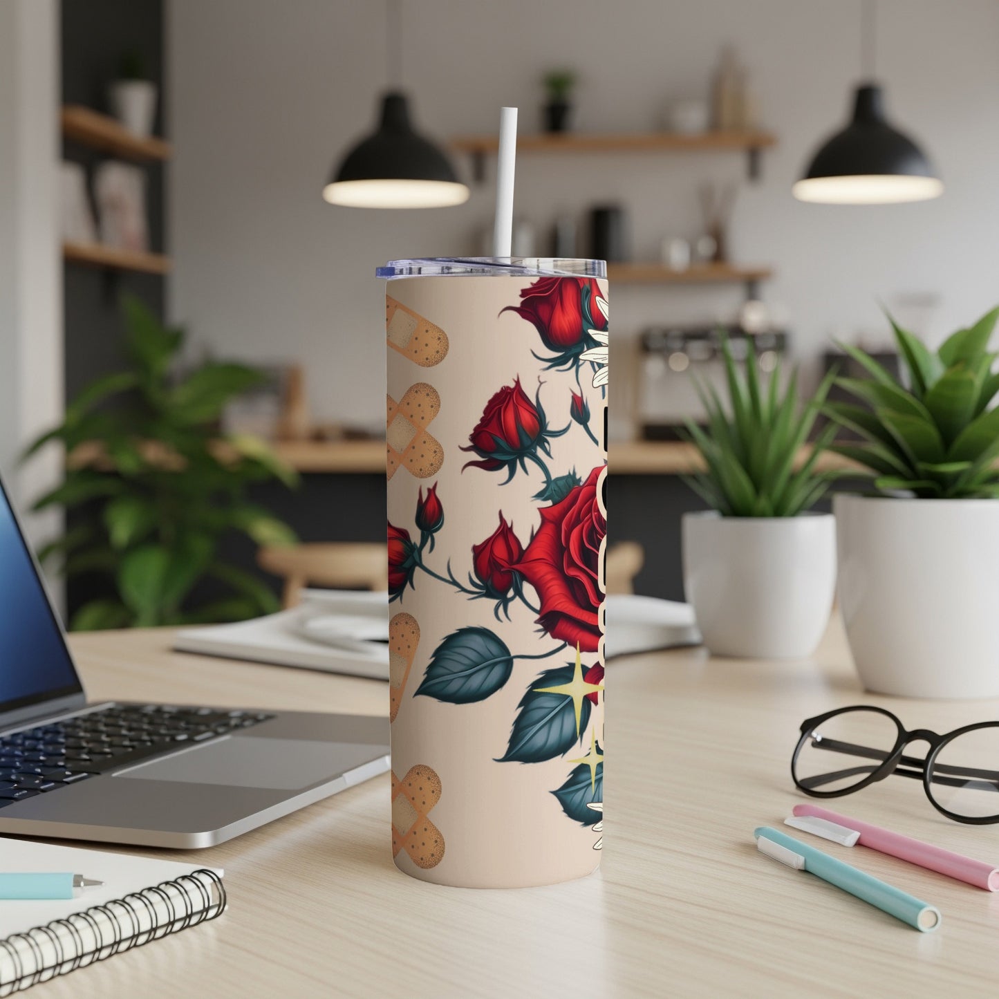 Red roses and medical cross pattern on a beige tumbler with straw.