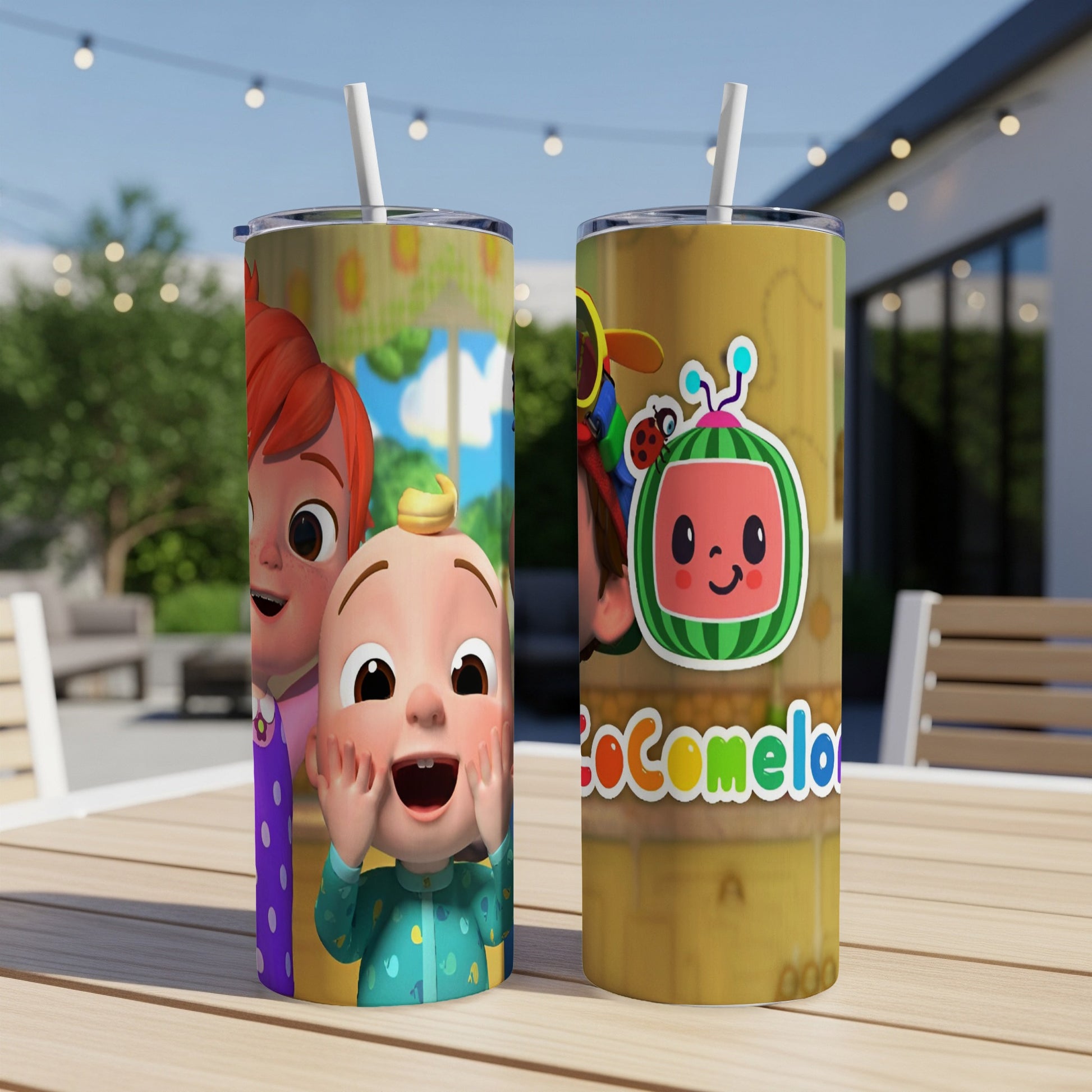 Two Cocomelon tumblers with colorful characters and a straw on a wooden table.