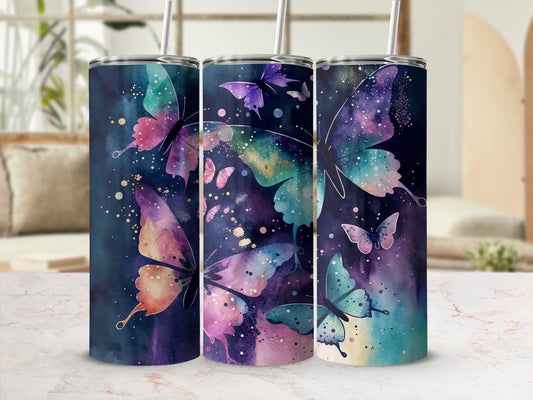 Three tumblers with colorful butterfly designs on a textured surface.