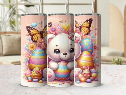 White teddy bear with butterflies, Easter eggs, and cupcakes on a pink tumbler.