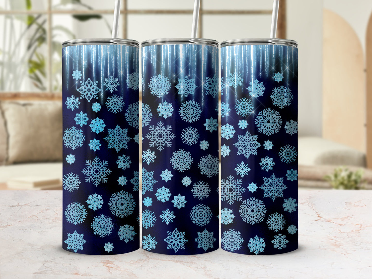 Three dark blue tumblers with blue snowflake and sparkle designs.