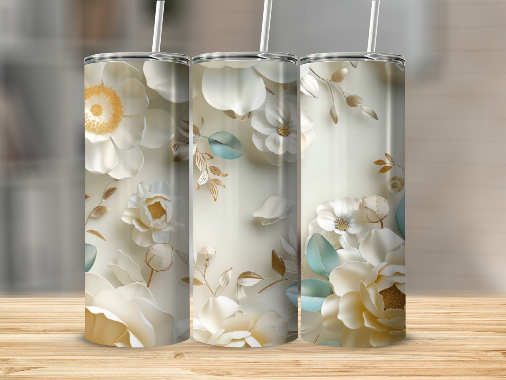Three floral tumblers with white and cream flowers and green leaves.