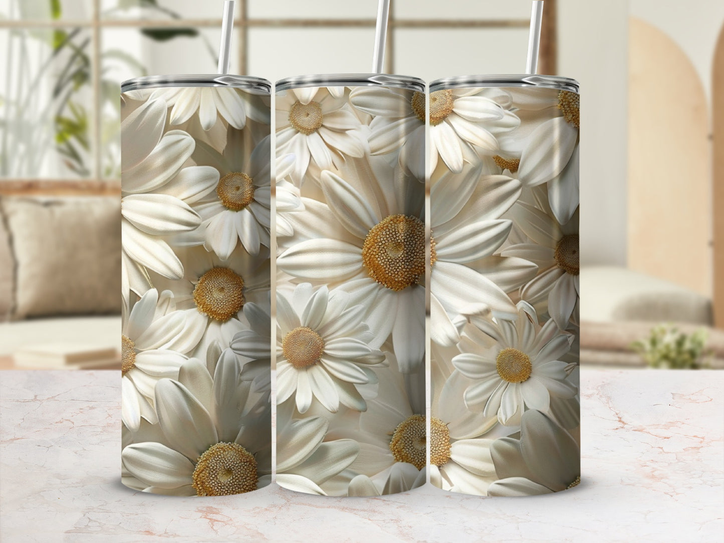 Three white daisy floral pattern tumblers with straws on a marble surface.