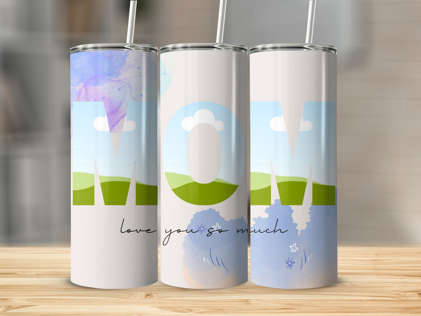 Three tumblers with "MOM" in large letters, landscape designs, and "love you so much" text.