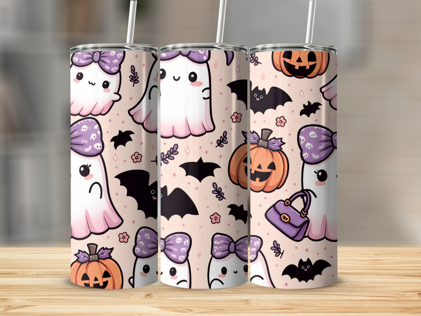 Three tumblers with Halloween ghosts, pumpkins, bats, and bows on a patterned background.