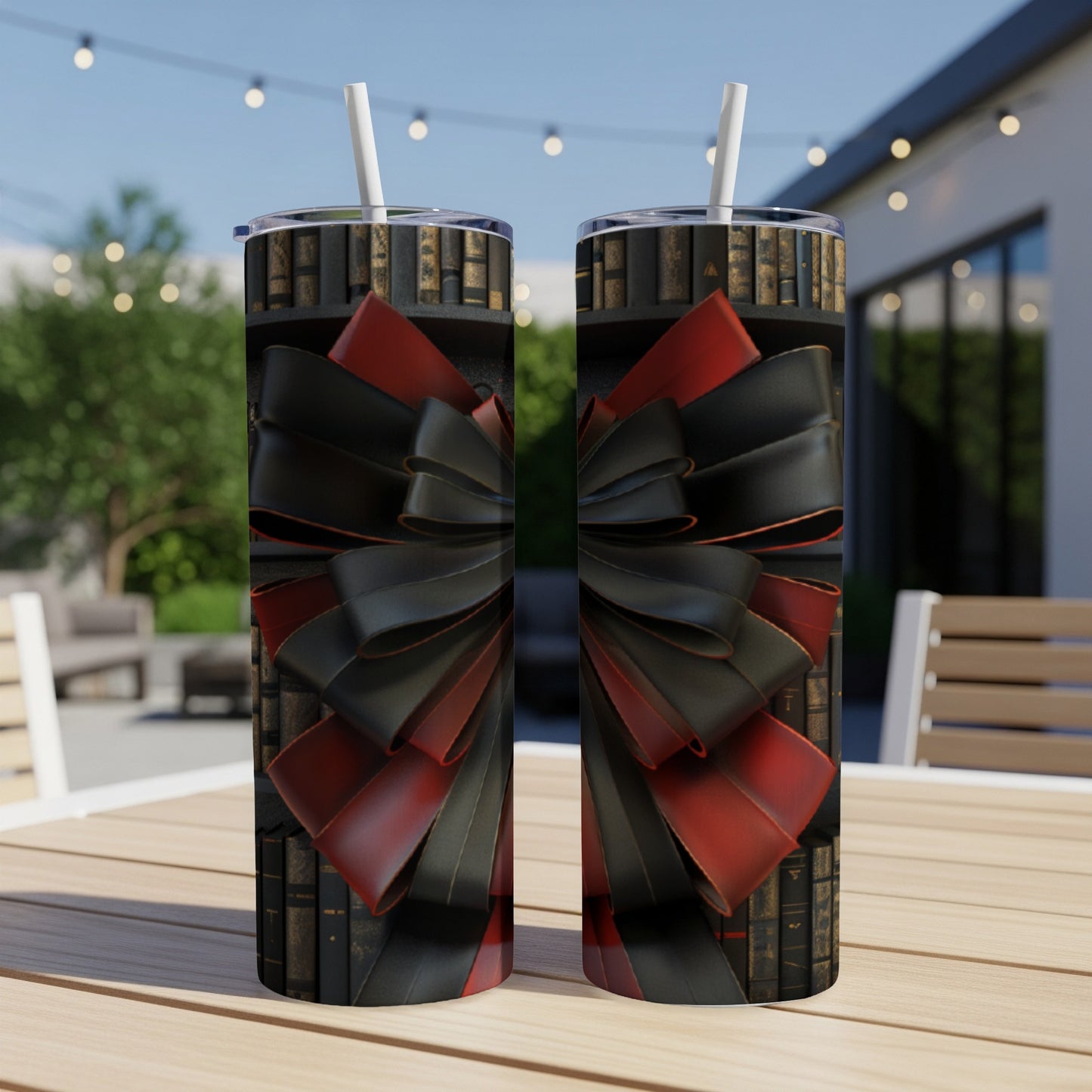 Two tumblers with a black and red ribbon bow design on a bookshelf background.