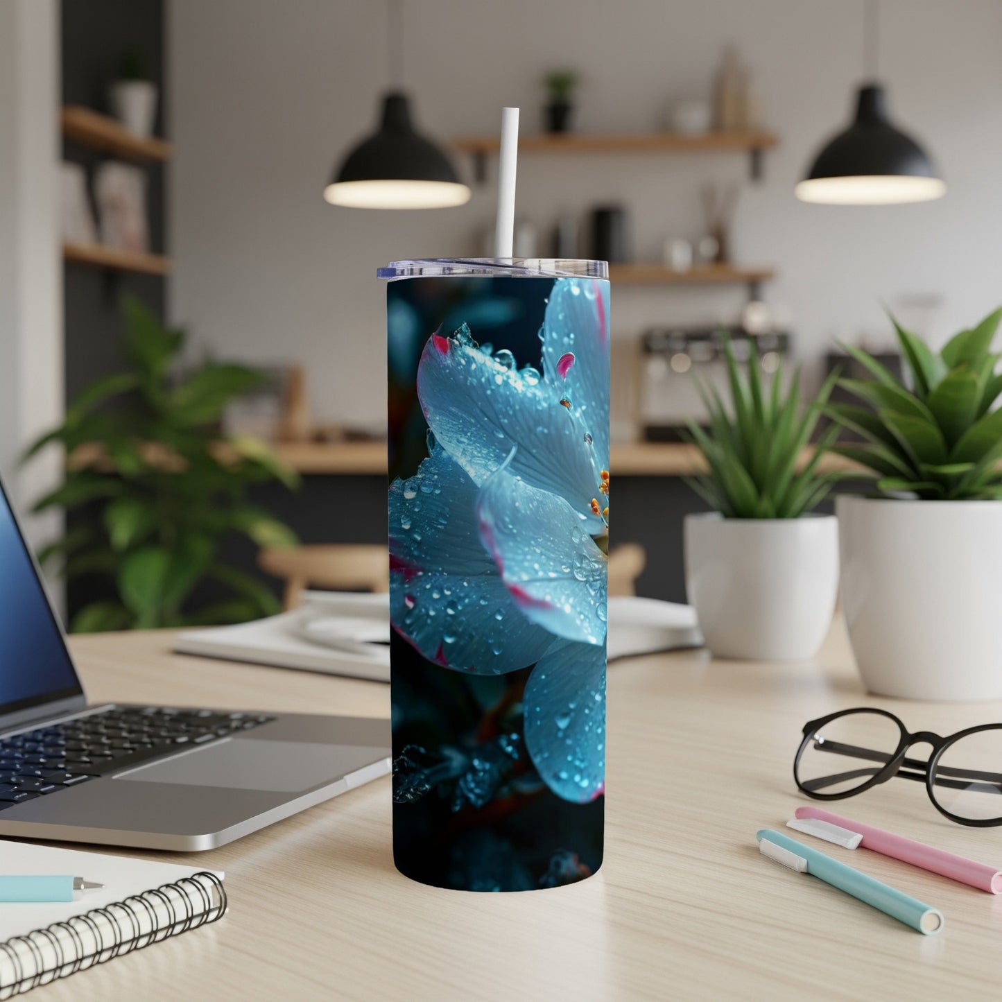 Blue flower with water droplets on a white tumbler with straw.