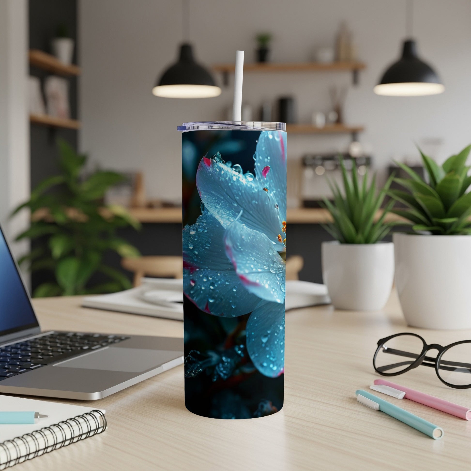 Blue flower with water droplets on a white tumbler with straw.