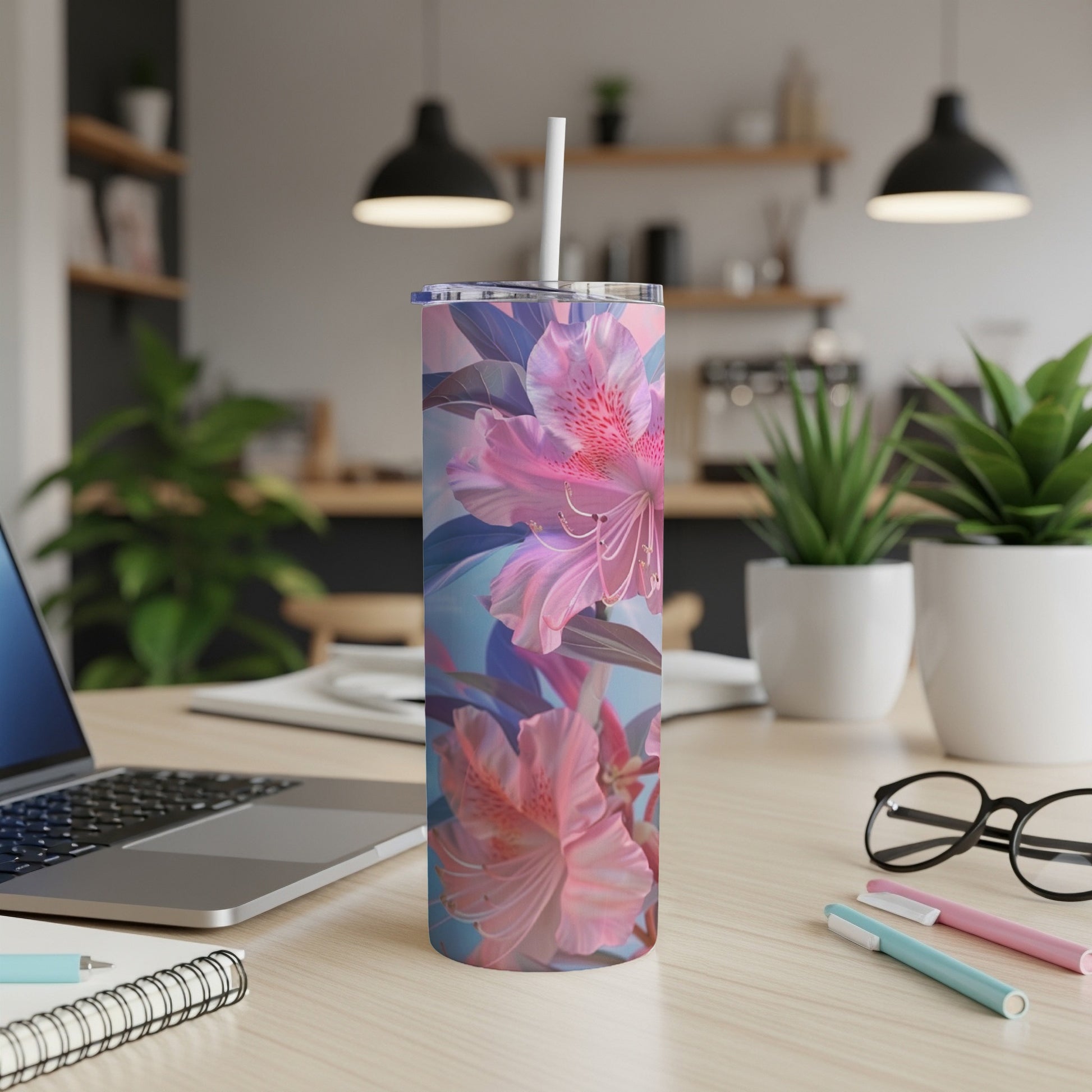 Pink and blue floral pattern on a white tumbler with a straw.