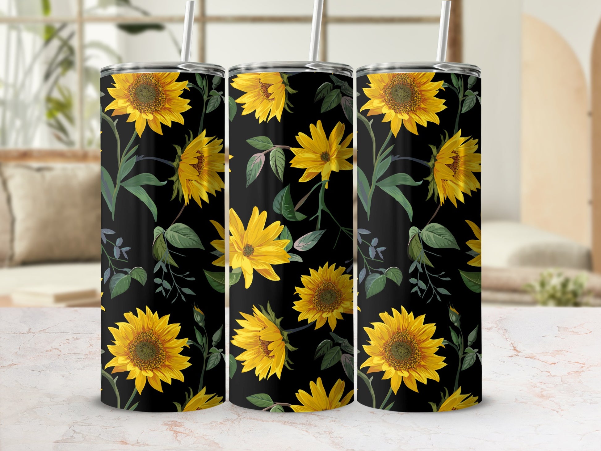 Three tumblers with a black background and a repeating sunflower floral pattern.