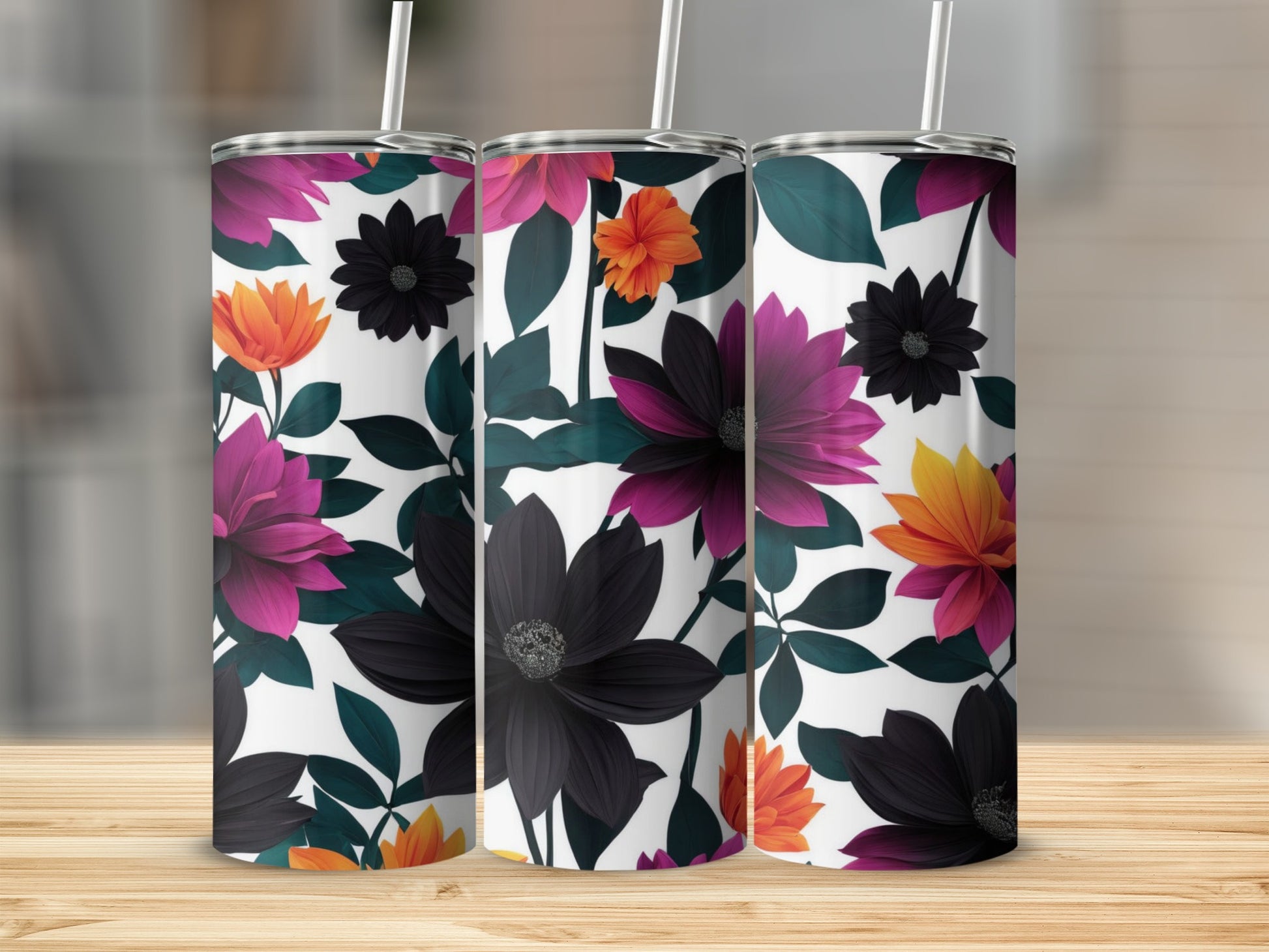 Three tumblers with a dark floral pattern on a wooden surface.