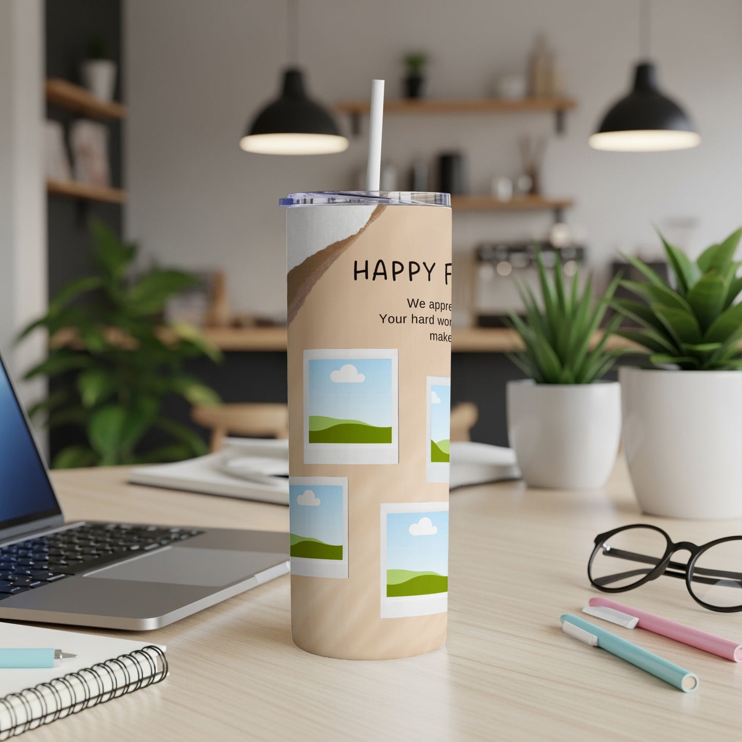 Tall tumbler with "HAPPY F" and scenic photo frames on a desk.