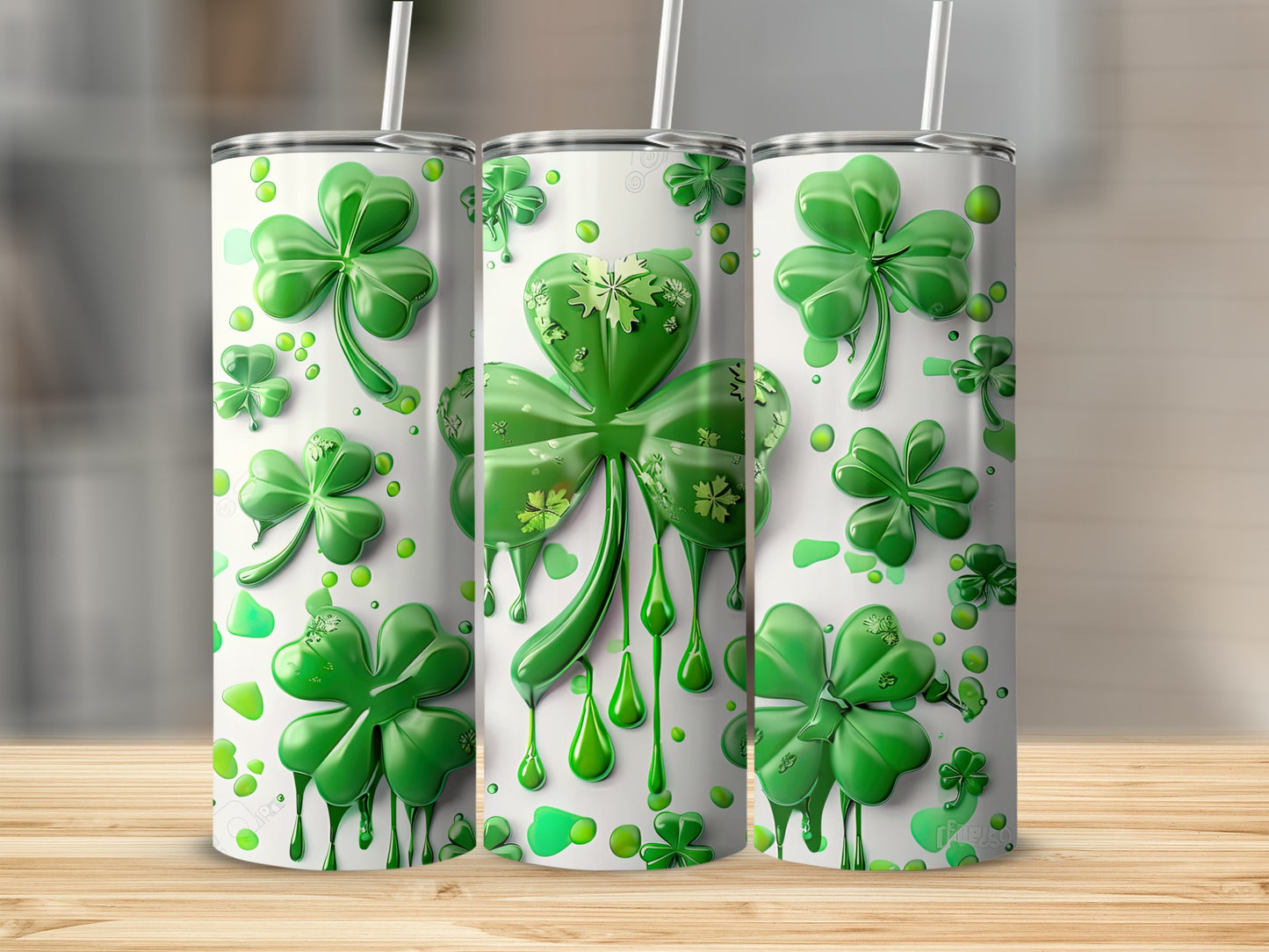 Three Saint Patrick's Day tumblers with dripping shamrock and clover designs.