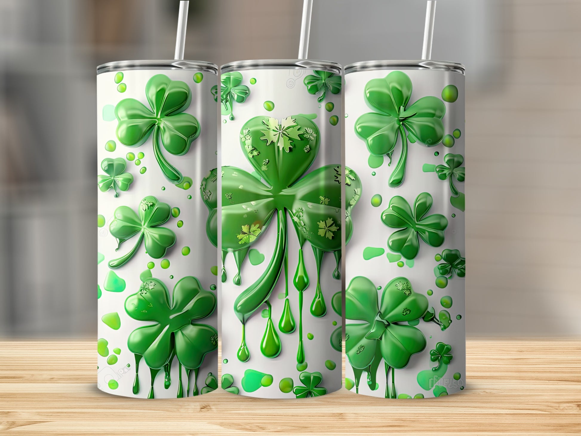 Three Saint Patrick's Day tumblers with dripping shamrock and clover designs.