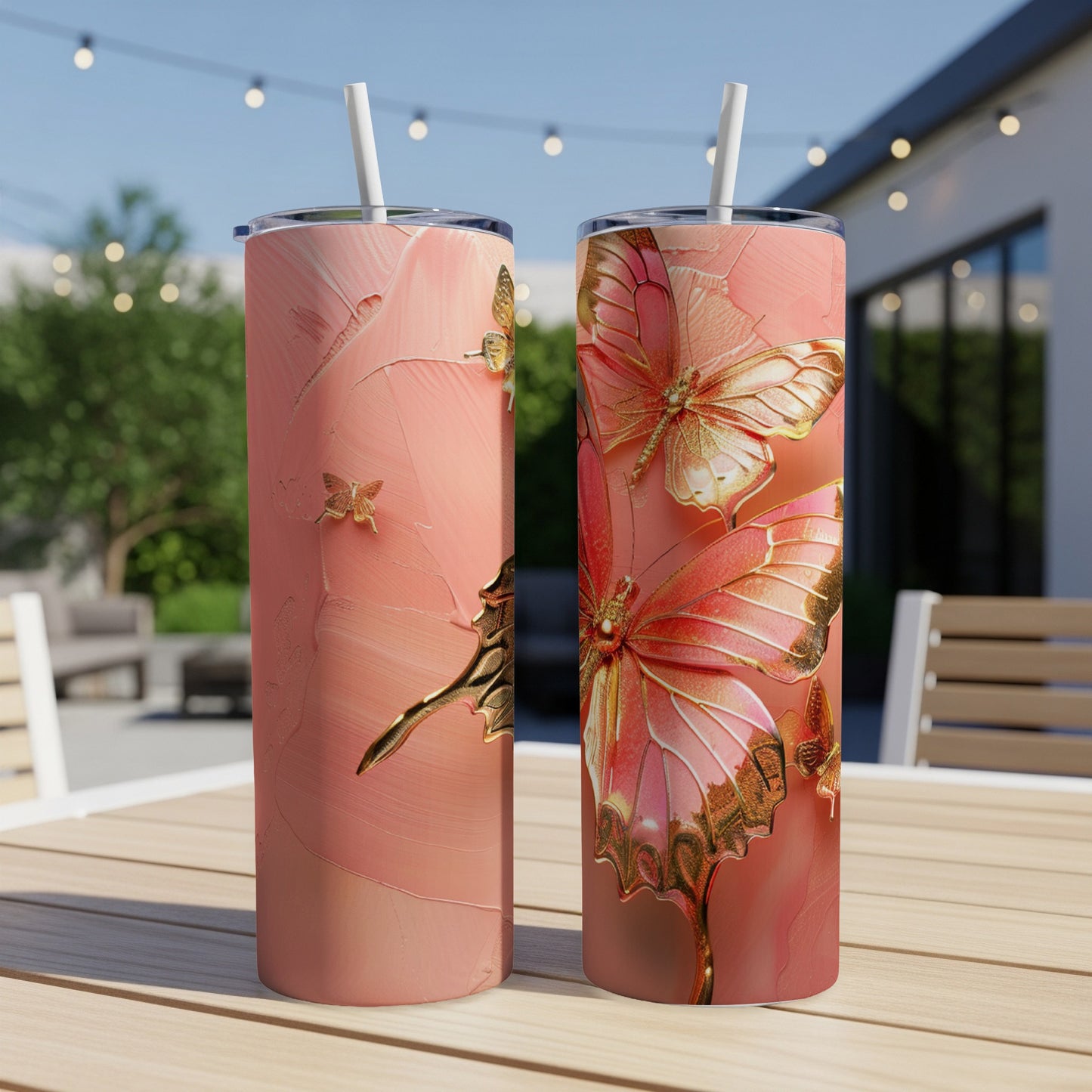 Two pink tumblers with golden butterflies on a wooden table.