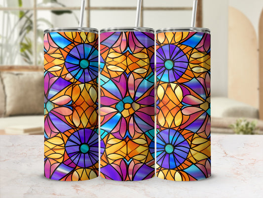 Three stained-glass effect tumblers with floral patterns and straws, displayed on a marbled surface.