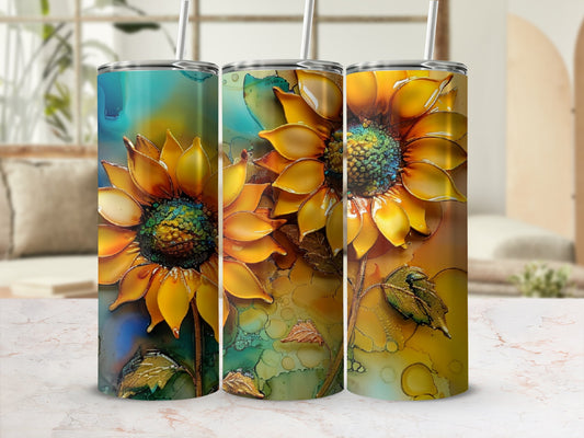 Three tumblers with a textured yellow sunflower design on a light marble surface.