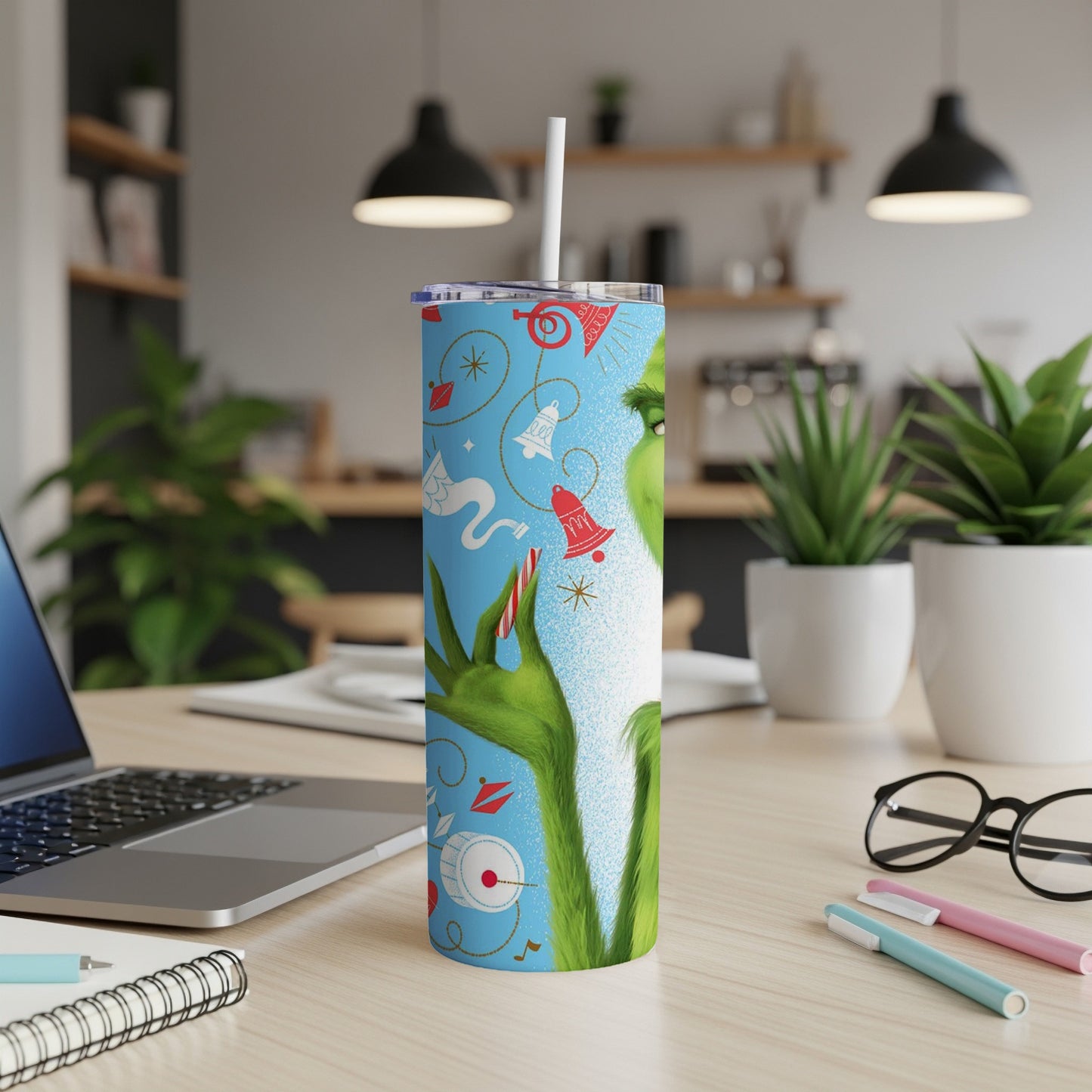 Grinch-themed tumbler with musical notes, bells, and holly sprigs.