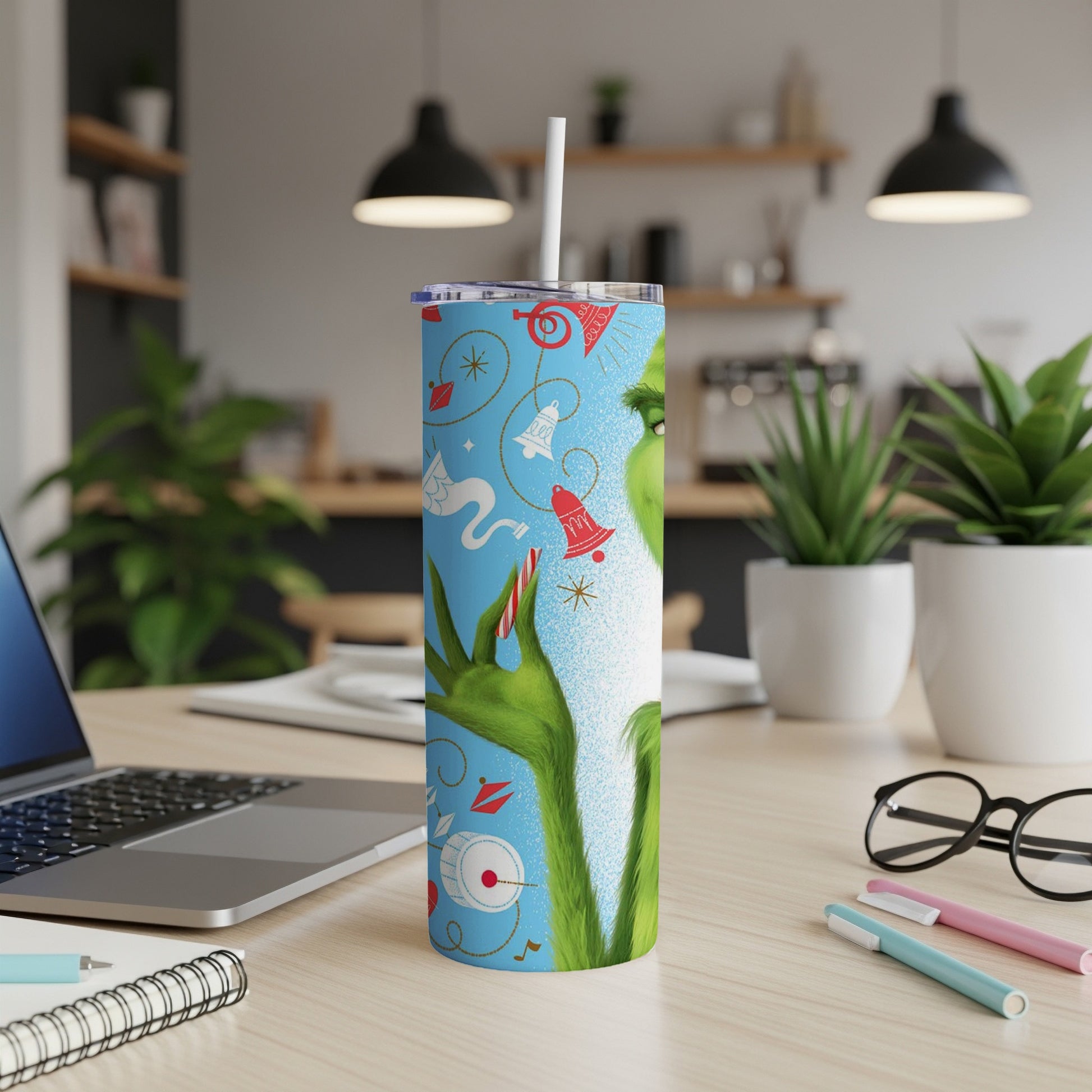 Grinch-themed tumbler with musical notes, bells, and holly sprigs.