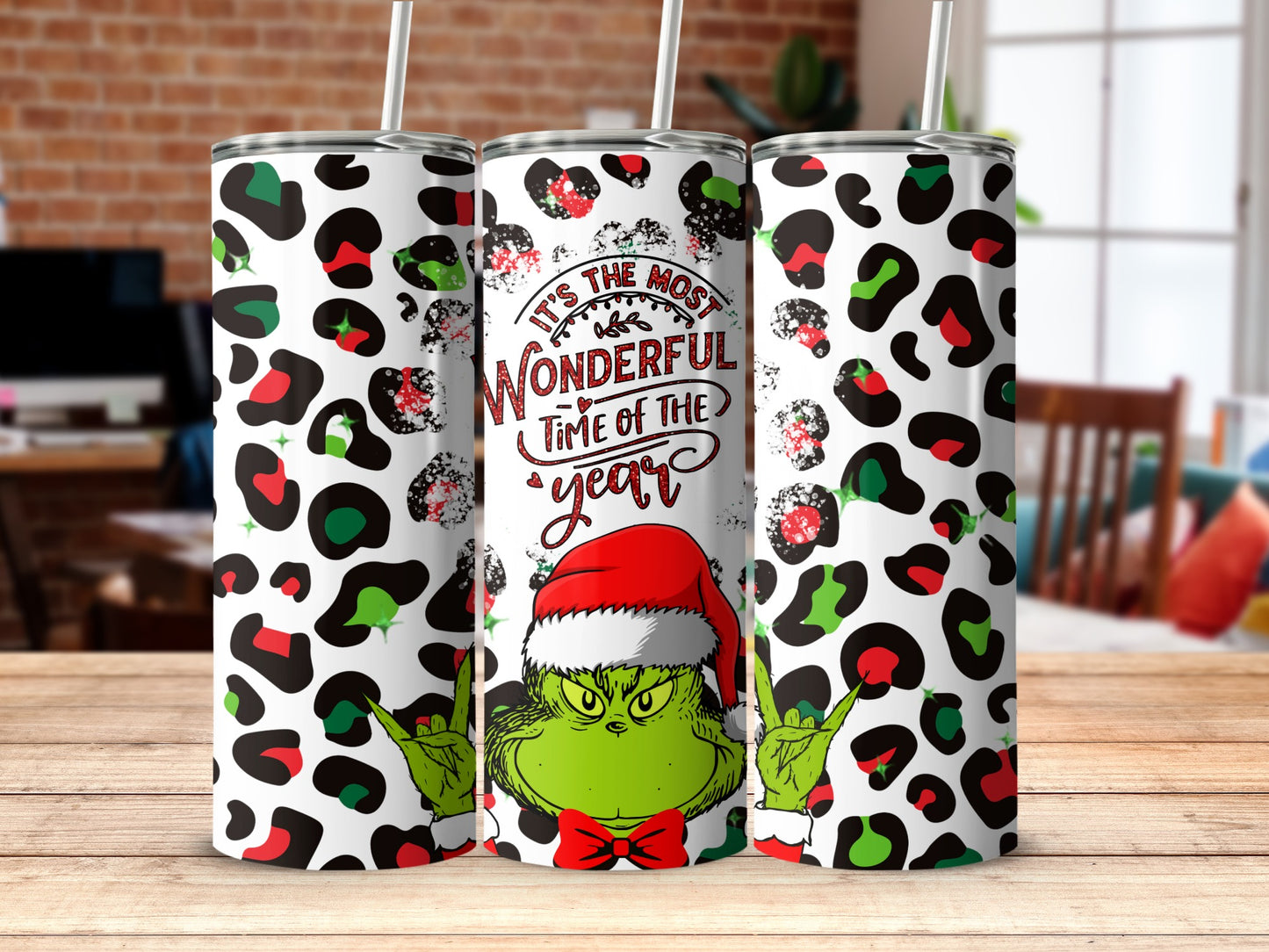 The Grinch with Santa hat and Christmas lights on a leopard print tumbler.