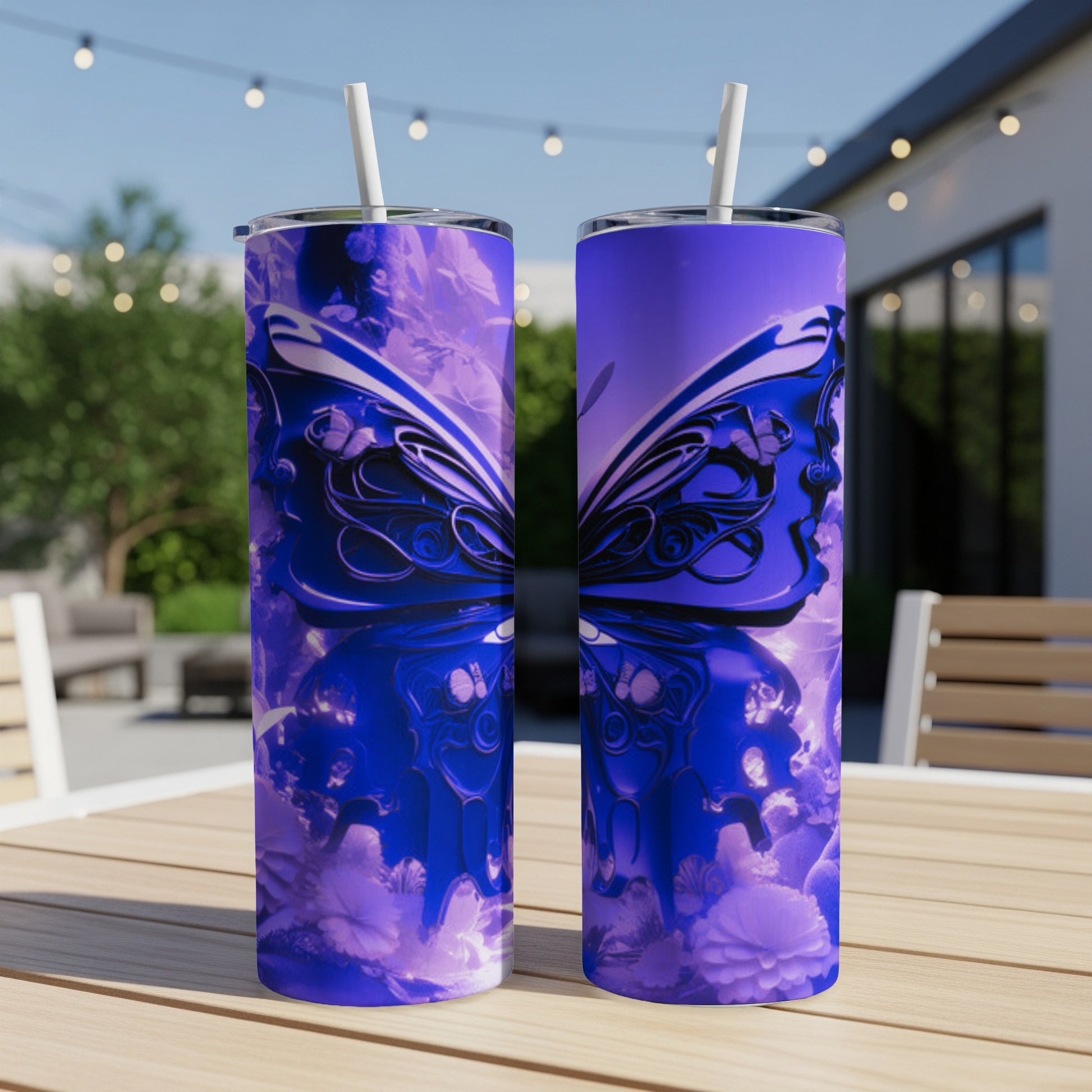 Two tumblers with a purple butterfly design sit on a wooden table outdoors.